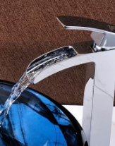 Clean water pouring from a faucet into a sink.
