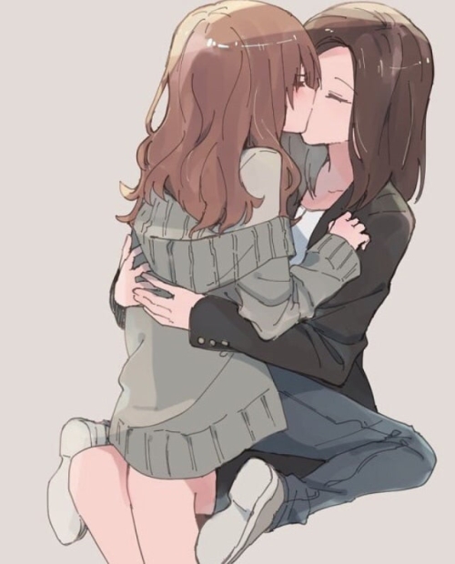 Two long haired lesbians kissing