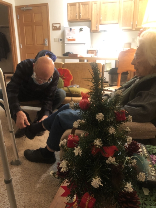 Tying 99 year old mother’s shoe laces