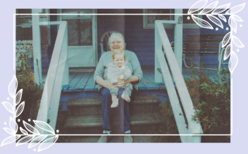 woman on steps of house with baby on lap