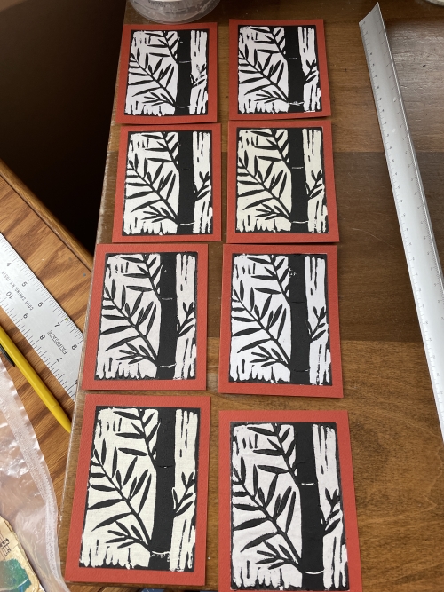 Picture of linoleum block printed bamboo on red background